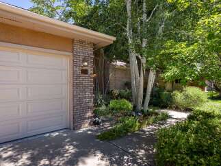 Welcome to this charming home featuring a classic brick exterior and a well-maintained garage door.