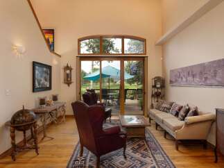 Experience the best of indoor-outdoor living in this stunning living room, featuring a grand fireplace and expansive sliding glass doors that open to a beautiful deck and backyard.
