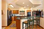 This spacious kitchen boasts beautiful wooden cabinetry and a sleek stainless steel refrigerator.