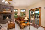Cozy living room featuring a warm brick fireplace and a plush leather sofa, perfect for relaxing evenings.