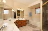 This spacious bathroom features a large vanity with dual sinks and ample counter space, perfect for busy mornings.