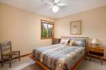 This cozy bedroom features a comfortable queen-size bed adorned with a Southwestern-inspired quilt and decorative pillows.