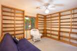 This room features extensive built-in wooden bookshelves, perfect for a home library or display space.