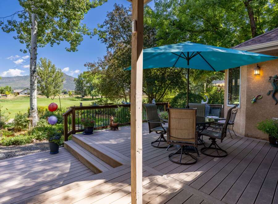 Enjoy outdoor living on this spacious deck, perfect for entertaining or relaxing.