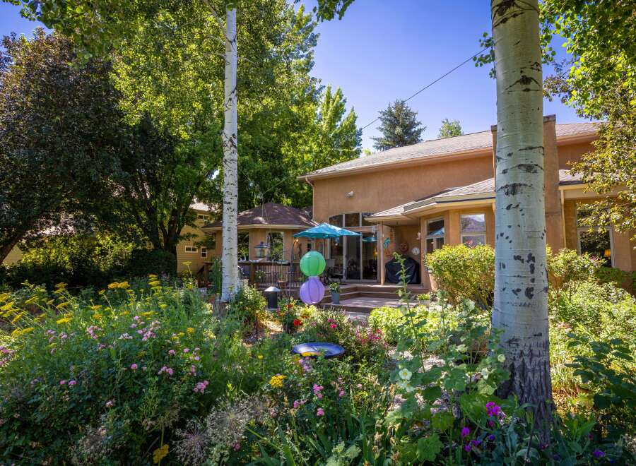 Enjoy outdoor living in this beautifully landscaped backyard featuring a spacious deck and a charming gazebo.