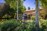 Enjoy outdoor living in this beautifully landscaped backyard featuring a spacious deck and a charming gazebo.