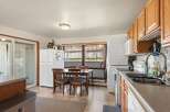 This charming kitchen features a dining area with a wooden table and chairs, perfect for family meals.