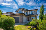 This stunning two-story home boasts a modern exterior with stone accents and a spacious two-car garage.