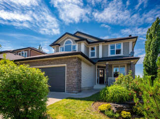 This stunning two-story home boasts a modern exterior with stone accents and a spacious two-car garage.