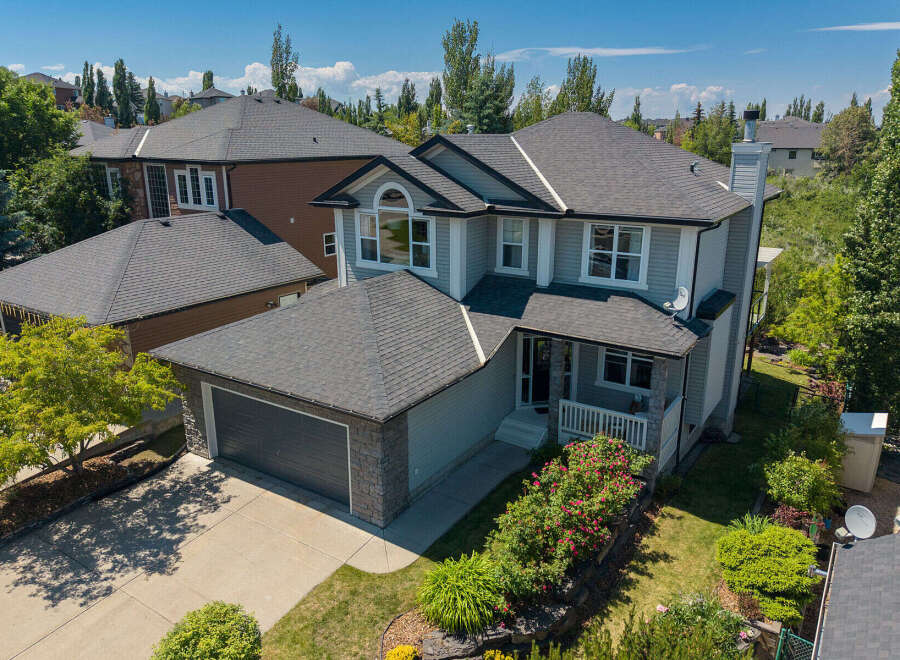 Discover this stunning family home featuring a spacious double garage and a beautifully landscaped front yard with vibrant rose bushes.