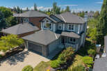 Discover this stunning family home featuring a spacious double garage and a beautifully landscaped front yard with vibrant rose bushes.