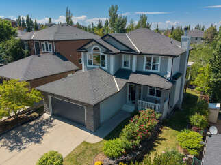 Discover this stunning family home featuring a spacious double garage and a beautifully landscaped front yard with vibrant rose bushes.