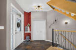 Step into a welcoming foyer featuring a bright white front door with decorative glass and a side window for natural light.