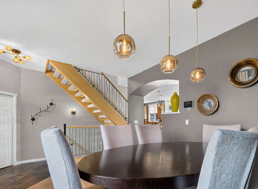 Experience elegant dining in this beautifully appointed space, featuring a rich, dark wood table surrounded by plush upholstered chairs.
