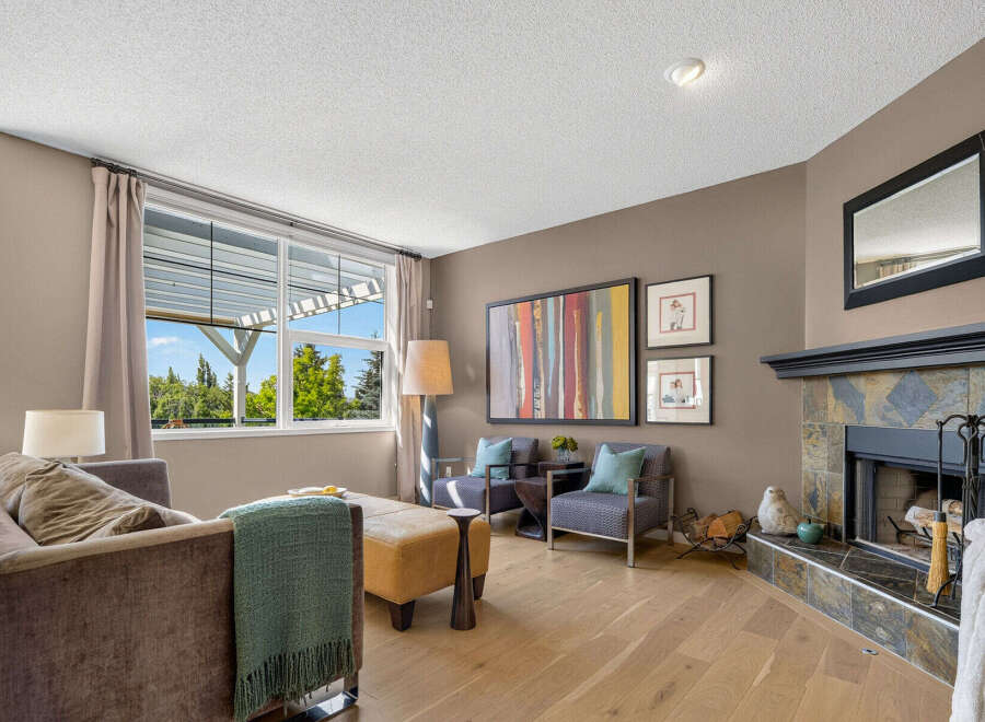 Step into this inviting living room, featuring a cozy seating area with plush sofas and armchairs perfect for relaxation.