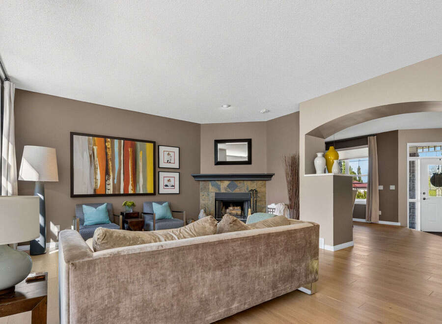 Step into this inviting living room, featuring a cozy fireplace and elegant decor.