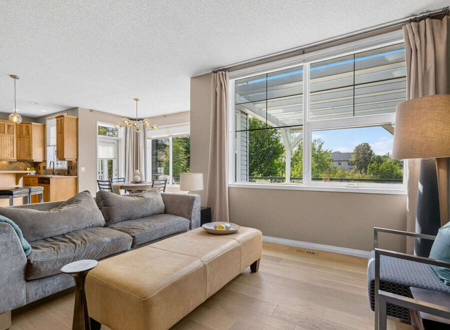 Experience modern living in this spacious open-concept home, featuring a gourmet kitchen with rich wood cabinetry and a large island perfect for entertaining.