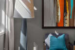 Experience modern living in this stylish room, featuring a striking abstract art piece that adds a vibrant pop of color.
