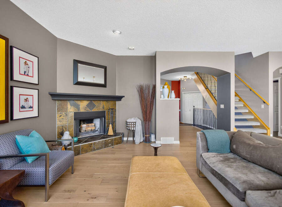 Step into this inviting living room, featuring a striking stone fireplace as the focal point.