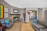 Step into this inviting living room, featuring a striking stone fireplace as the focal point.