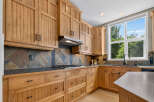 This beautifully appointed kitchen features custom wood cabinetry with intricate detailing and ample storage.