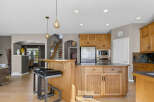 This spacious kitchen boasts beautiful natural wood cabinetry and a large island, perfect for meal preparation and casual dining.