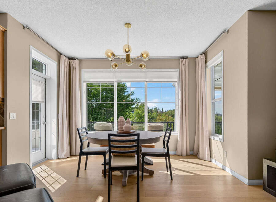 Enjoy bright and airy meals in this charming dining area, featuring a round pedestal table perfect for intimate gatherings.