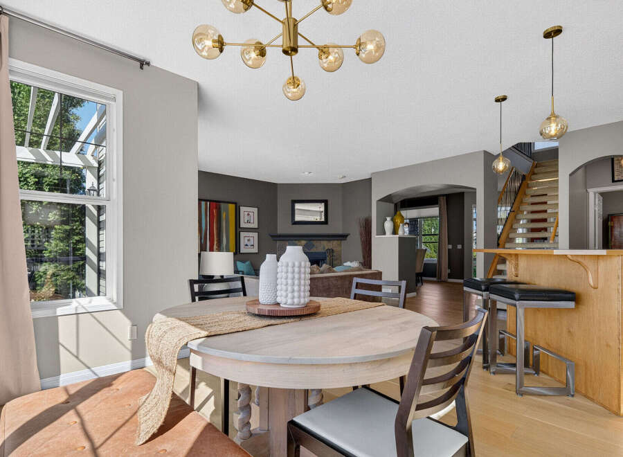 This inviting dining area features a round wooden table with comfortable seating, perfect for family meals.