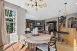 This inviting dining area features a round wooden table with comfortable seating, perfect for family meals.