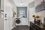 Discover the convenience of this functional laundry room, featuring a stacked washer and dryer set perfect for maximizing space.