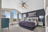 Experience luxury in this stunning master suite, featuring a vaulted ceiling and a large arched window that floods the room with natural light.