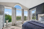 Experience breathtaking views from this stunning bedroom, featuring expansive windows that flood the space with natural light.