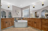 Indulge in luxury with this stunning master bathroom, featuring a spacious corner soaking tub perfect for relaxation.