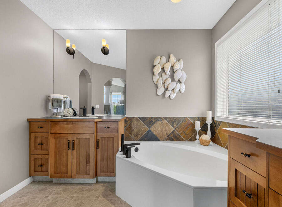 Indulge in this luxurious bathroom featuring a spacious soaking tub, perfect for unwinding after a long day.