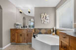 Indulge in this luxurious bathroom featuring a spacious soaking tub, perfect for unwinding after a long day.