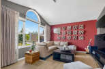 Experience modern living in this spacious living room, featuring a large sectional sofa perfect for gatherings.