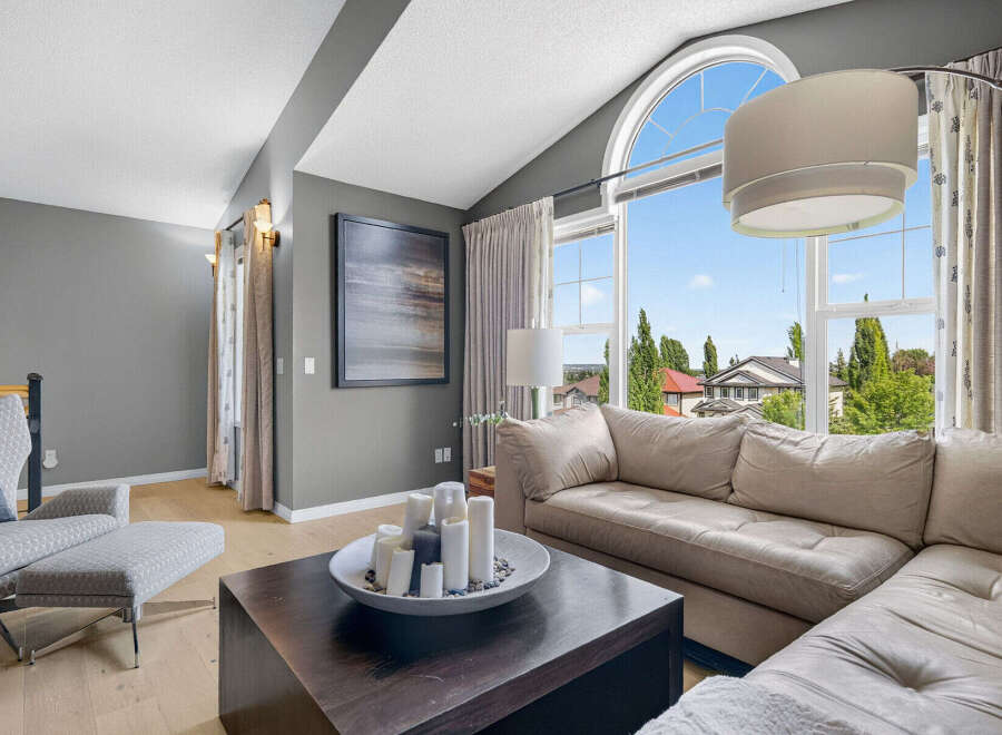 Experience luxurious living in this spacious living room, featuring a large sectional sofa perfect for relaxation and entertaining.