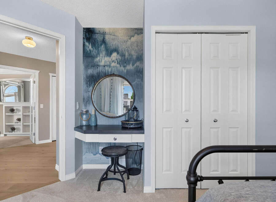 Discover a stylish vanity area with a round mirror and decorative accents, perfect for a dressing room or bedroom.