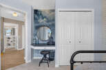 Discover a stylish vanity area with a round mirror and decorative accents, perfect for a dressing room or bedroom.