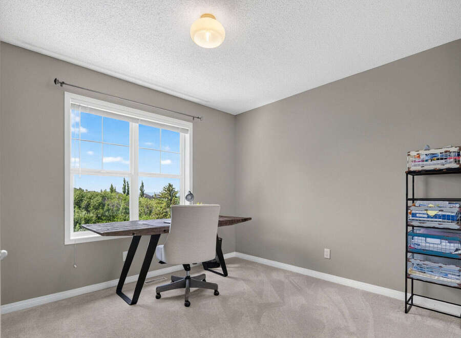 This home office space features a large window with a scenic view, perfect for natural light and inspiration.