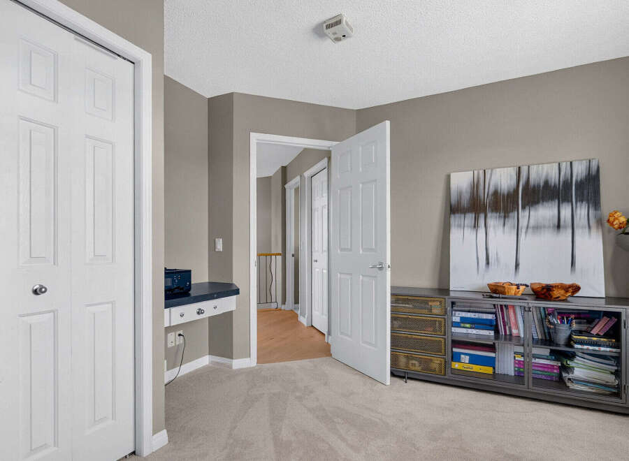 Discover a versatile space perfect for a home office or study nook, featuring a built-in desk with ample storage.