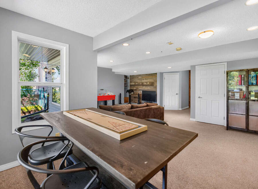 This finished basement offers a fantastic entertainment space, complete with a shuffleboard table and a foosball table.
