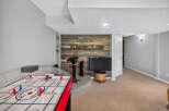 This basement recreation room offers a perfect blend of entertainment and relaxation.