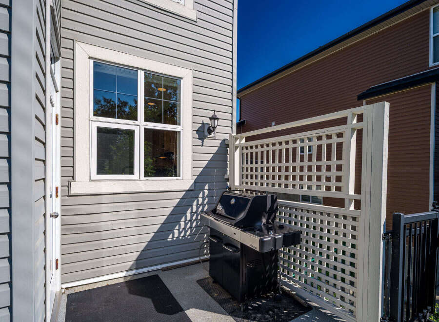 Enjoy outdoor living with this charming patio space, complete with a gas grill perfect for summer cookouts.