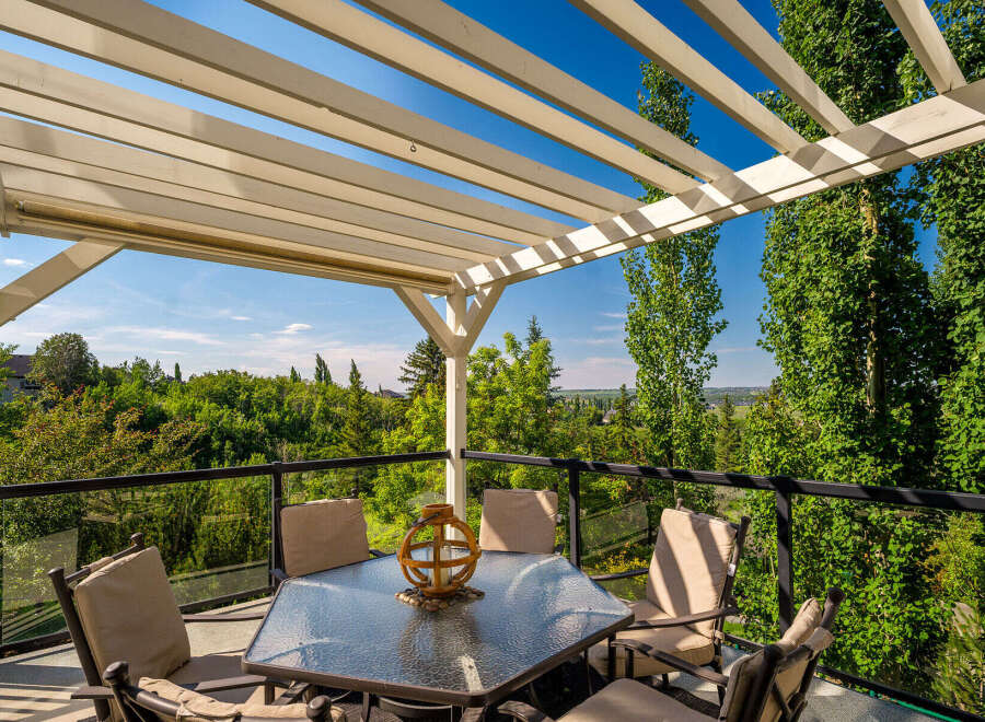 Enjoy breathtaking views from this stunning covered patio, perfect for outdoor dining and relaxation.