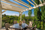 Enjoy breathtaking views from this stunning covered patio, perfect for outdoor dining and relaxation.