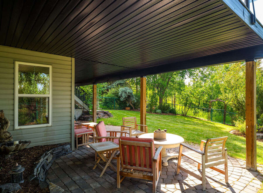 Enjoy outdoor living on this covered patio, perfect for entertaining or relaxing in any weather.