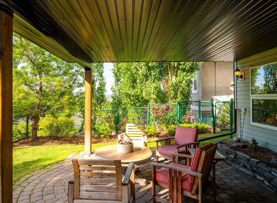 Enjoy outdoor living in this covered patio space, perfect for relaxing or entertaining.