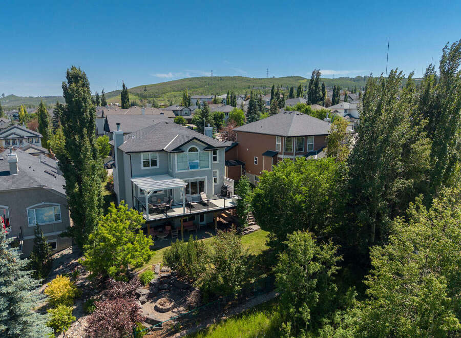 Experience luxury living in this stunning multi-level home, boasting a spacious backyard with a fire pit and mature trees for ultimate privacy.