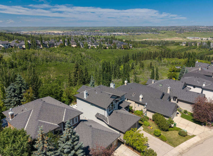Experience luxury living in this stunning aerial view of a suburban neighborhood, showcasing meticulously designed homes with elegant architecture and spacious layouts.